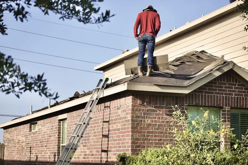 Professional roofer working on a residential roof in Aransas Pass